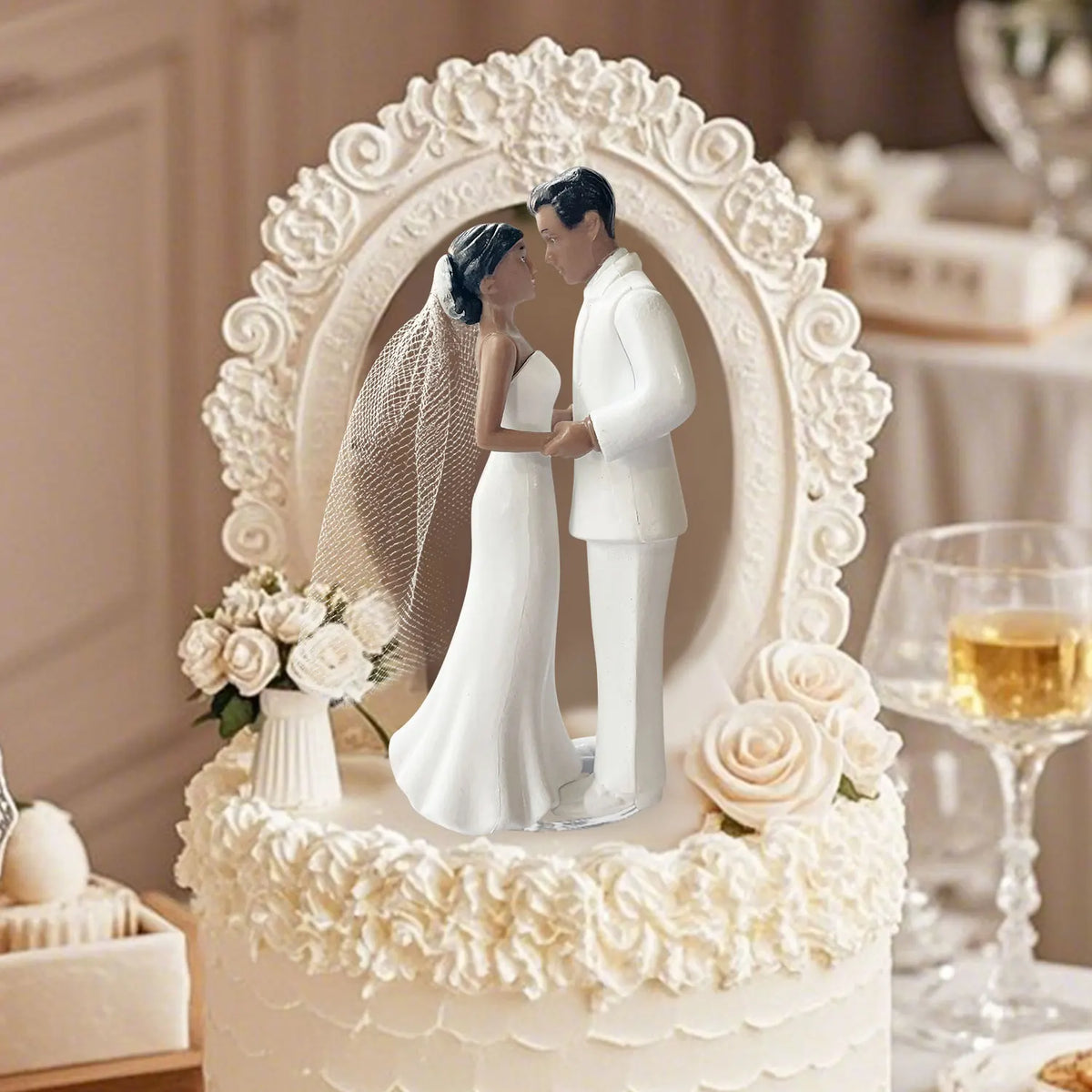 Elegant wedding cake topper featuring a bride and groom in white attire surrounded by floral accents