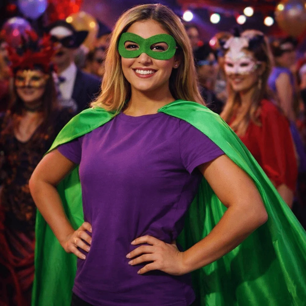 A young woman wearing a purple shirt and a green cape with a green eye mask, posing for a photo.