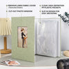 A linen photo album with a textured green cover and a clear window displaying a photograph, shown next to plastic pockets.