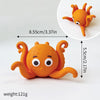 An orange ocean animal set featuring a whale, octopus, and turtle topper.