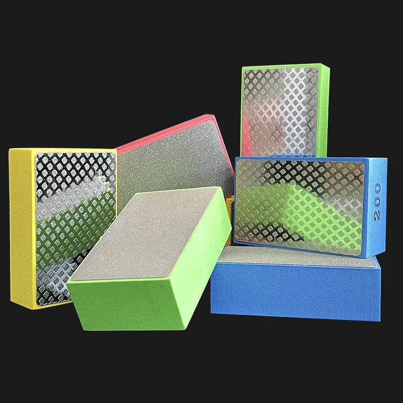 A collection of green, pink, and blue diamond hand polishing pads for stone, tile, and glass.