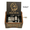 A wooden music box featuring an anime character design and a mechanism.