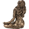A bronze statue of a woman with long flowing hair in a meditative pose, representing Mother Earth Gaia.