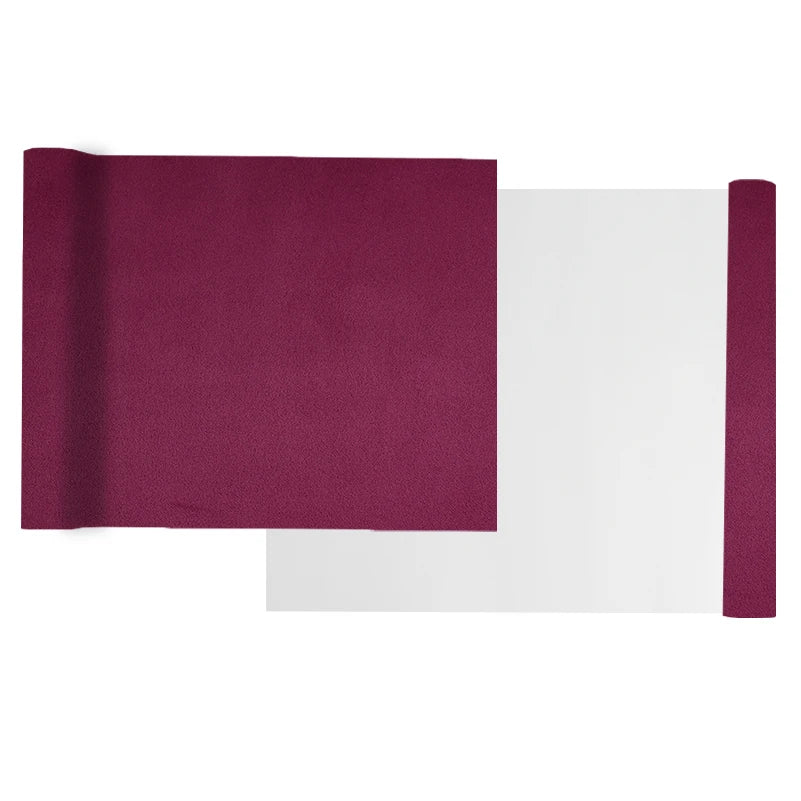 A roll of deep magenta suede wrap fabric with a white backing, used for DIY projects.