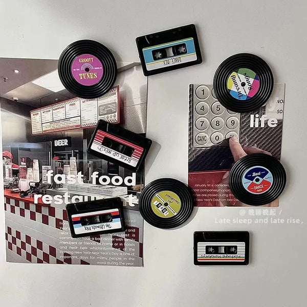 A collection of four retro cassette tape fridge magnets featuring various labels and designs.