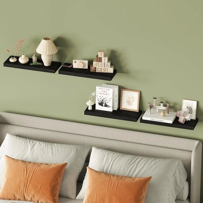 A modern wooden floating wall shelf organizer displaying various decorative items and framed photos on a green wall.