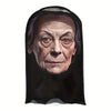 A dark mask depicting an elderly face with deep wrinkles and intense eyes.