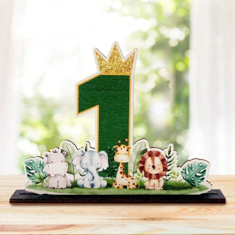 A wooden ornament featuring a gold crown and a number one, surrounded by small jungle animals like a lion and an elephant.