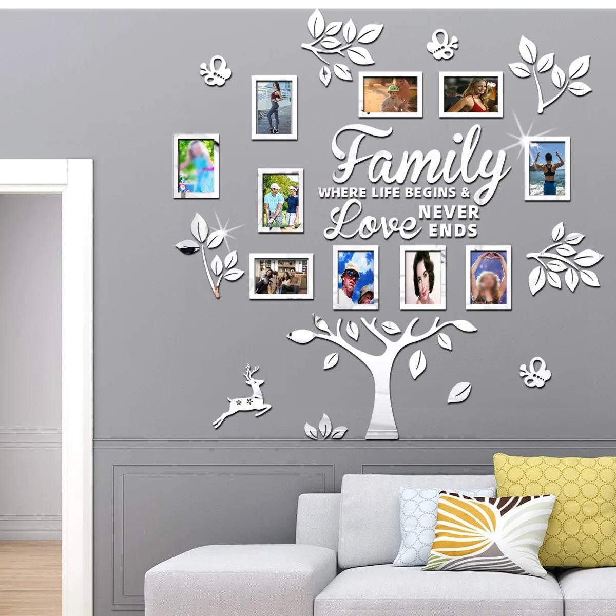 A gray wall decorated with a family tree photo collage featuring various framed pictures and leafy silhouettes.