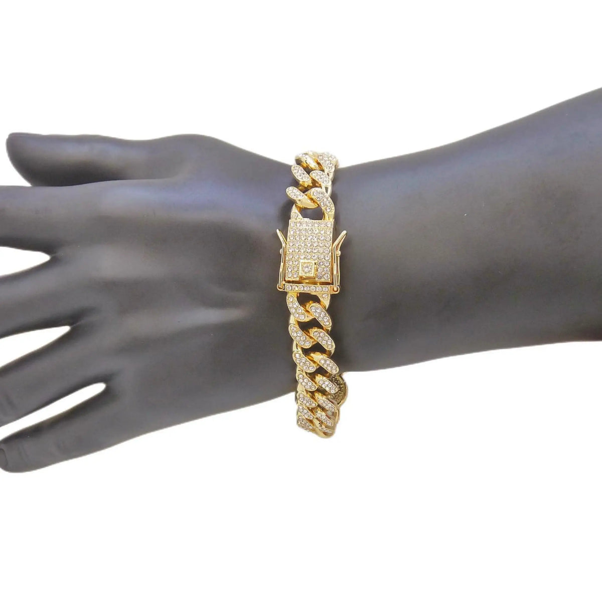A close-up of a gold Cuban link bracelet with a religious faith design worn on a dark hand.