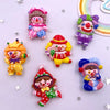 A collection of colorful resin clown charms featuring various expressions and outfits for DIY crafts