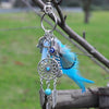 Silver bohemian dream catcher keychain featuring a blue feather and dangling silver tassels.