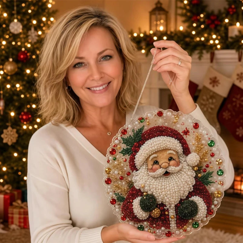 A smiling woman holds a finished Christmas pearl diamond painting suncatcher with a metal chain.