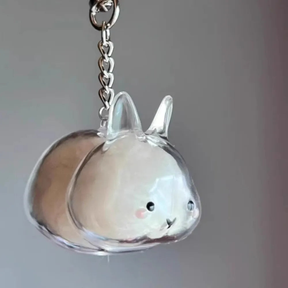 Clear acrylic rabbit charm hanging from a silver chain keychain