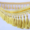 Golden tassel fringe trim used for decorative edging on curtains or DIY projects