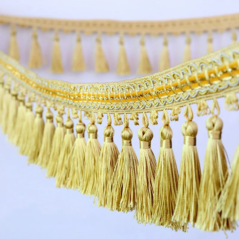 Golden tassel fringe trim used for decorative edging on curtains or DIY projects
