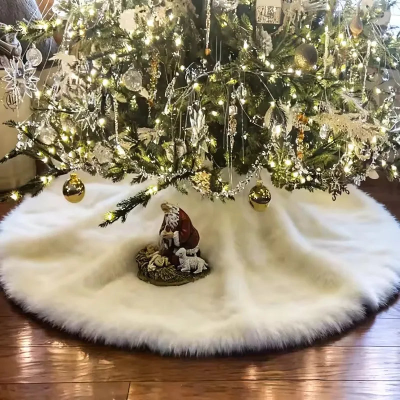 A lush green Christmas tree decorated with lights and ornaments sits atop a white faux fur skirt.