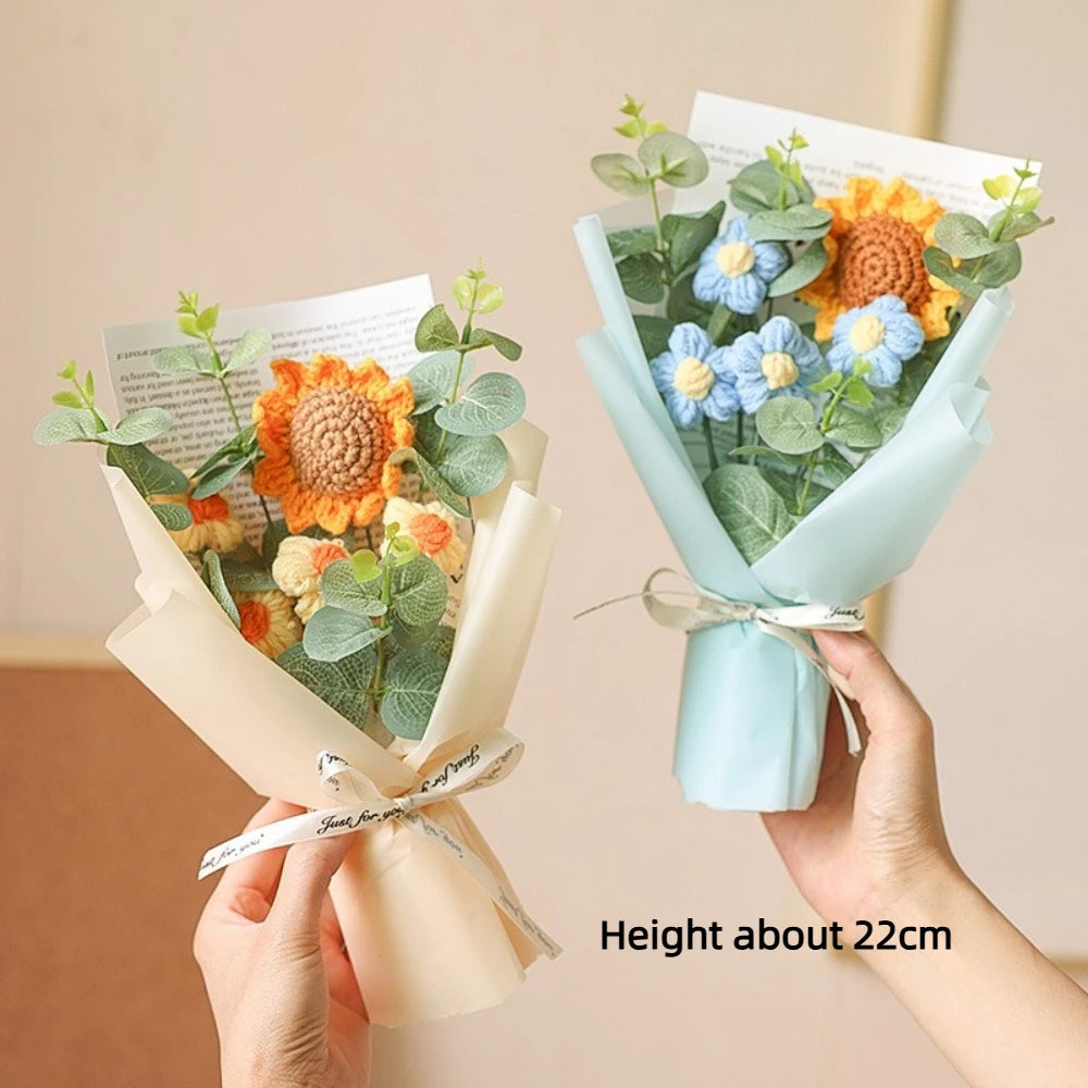 A bouquet of handcrafted crochet sunflowers and daisies in soft green and yellow tones, presented in light blue wrapping.