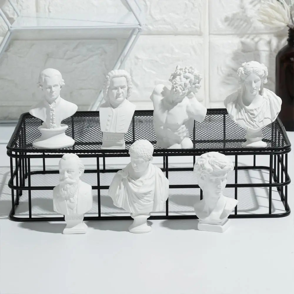 A collection of plaster bust miniatures depicting classical Greek mythology figures.