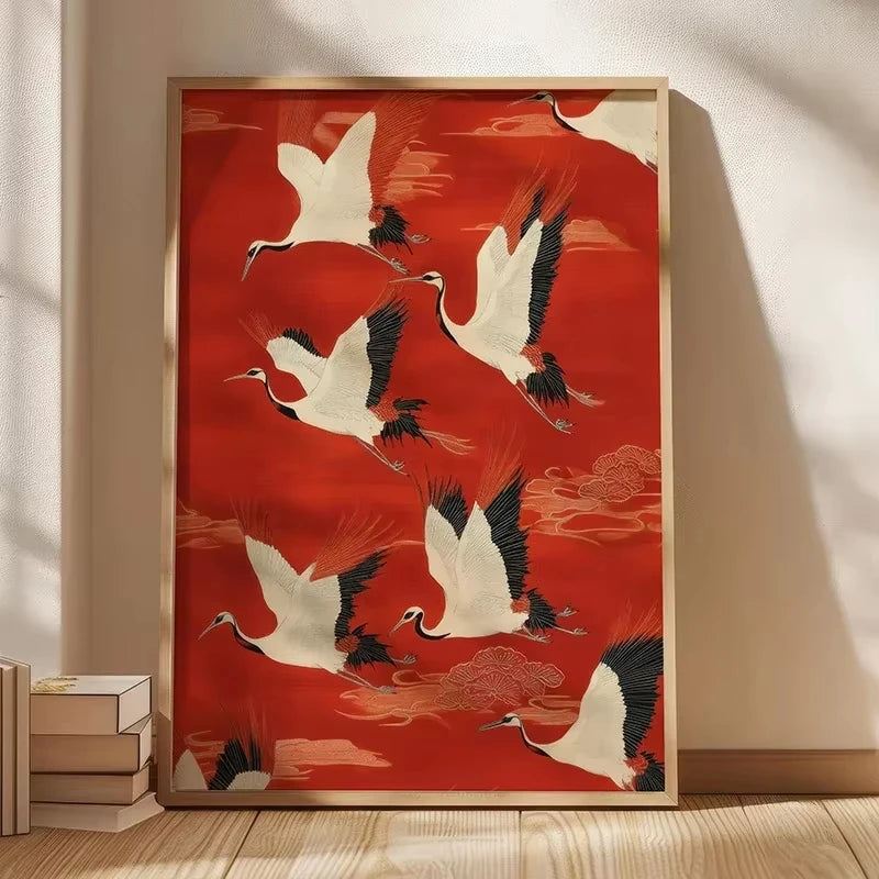 Red canvas wall art featuring white cranes in flight with gold framing.