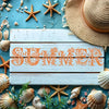 Wooden planks display reusable floral alphabet stencils for painting and decals surrounded by seashells and starfish