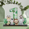 Wooden ornament featuring cute jungle animals like a giraffe, tiger, and elephant in green foliage.