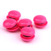 A set of ten bright pink refrigerator magnets stacked and scattered on a white background.