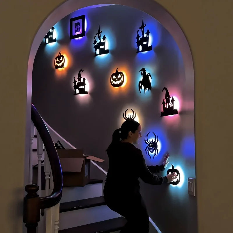 Halloween wall stickers featuring various spooky figures and pumpkins illuminated by LED night lights on a staircase