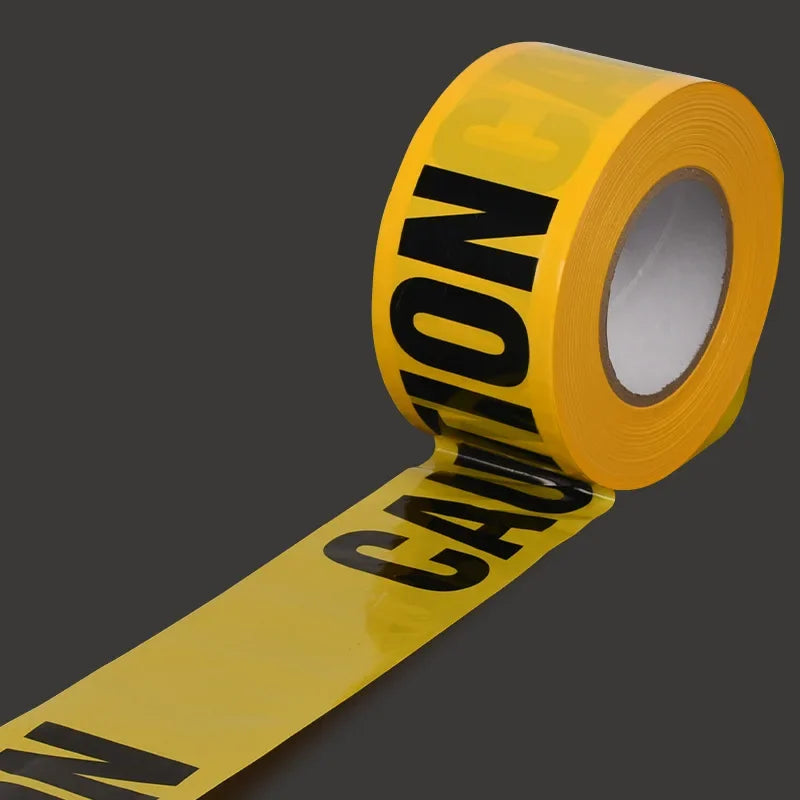 Yellow caution tape rolled on a spool with black lettering, used for spooky warning barricades.