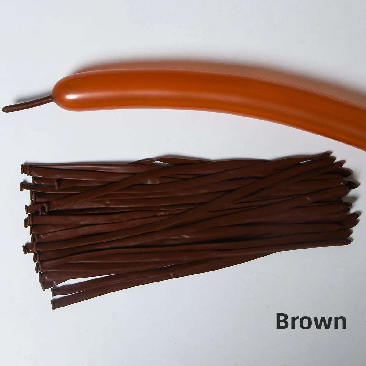 A brown latex strip balloon is shown next to a bundle of brown latex strips.