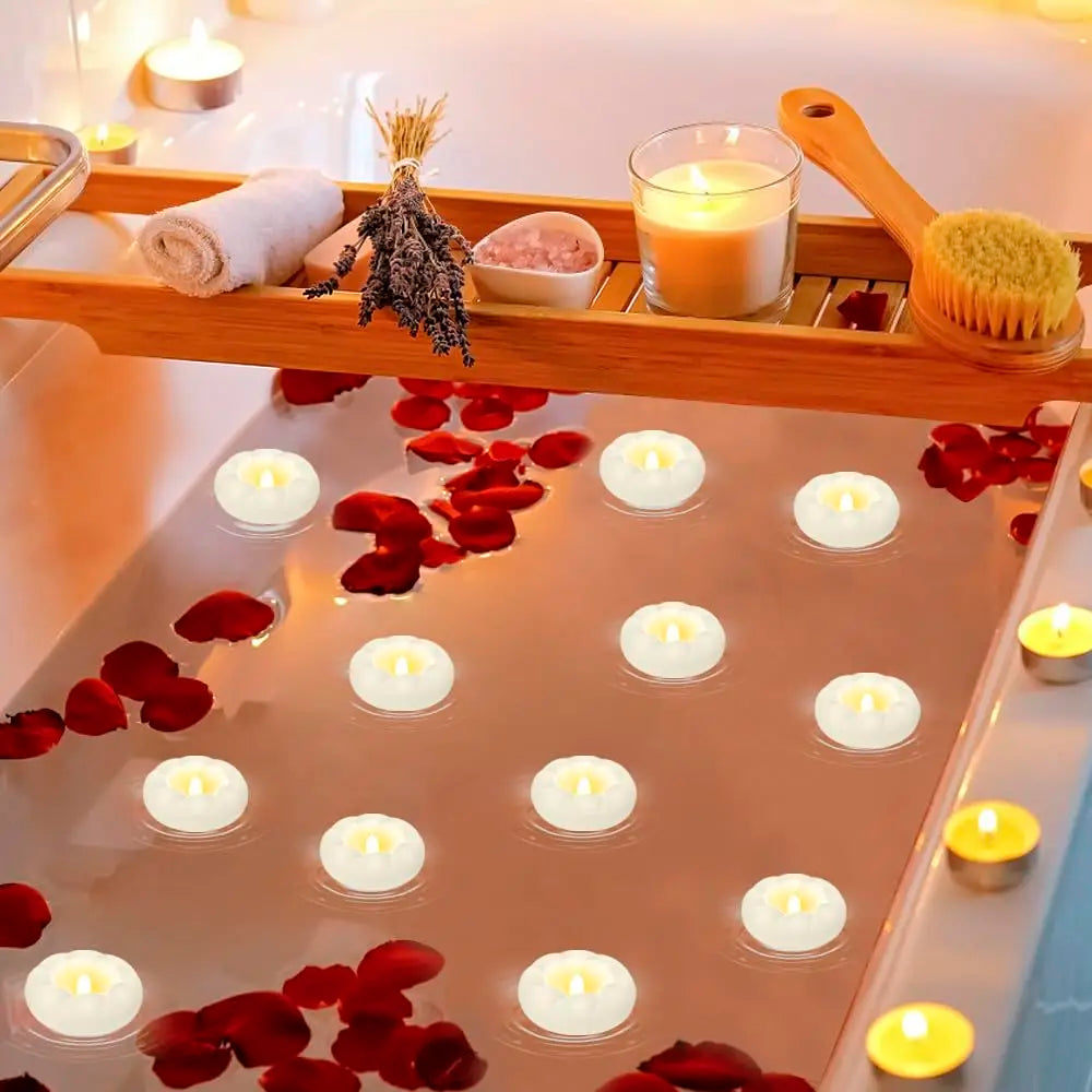 A tray of floating candles in a glass pan surrounded by red rose petals and wood accents.