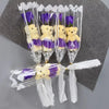 A bouquet of artificial rose soap featuring yellow teddy bears with purple accents, wrapped in clear cellophane.