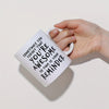 A hand is holding a white ceramic coffee mug with black text that reads Sometimes you forget that you're awesome so this is y