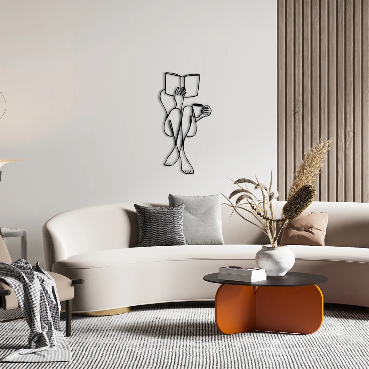 Elegant metal line art wall decor featuring a silhouette of a person reading a book on a light gray wall above a beige sofa.
