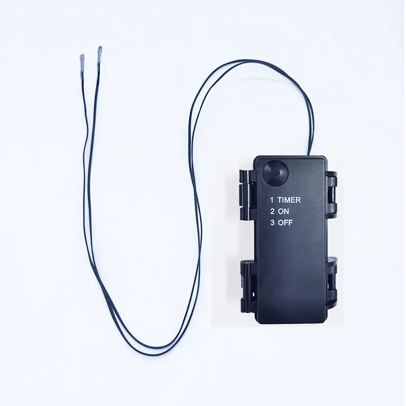 A black electronic timer device with a wire, used for Halloween and decor.