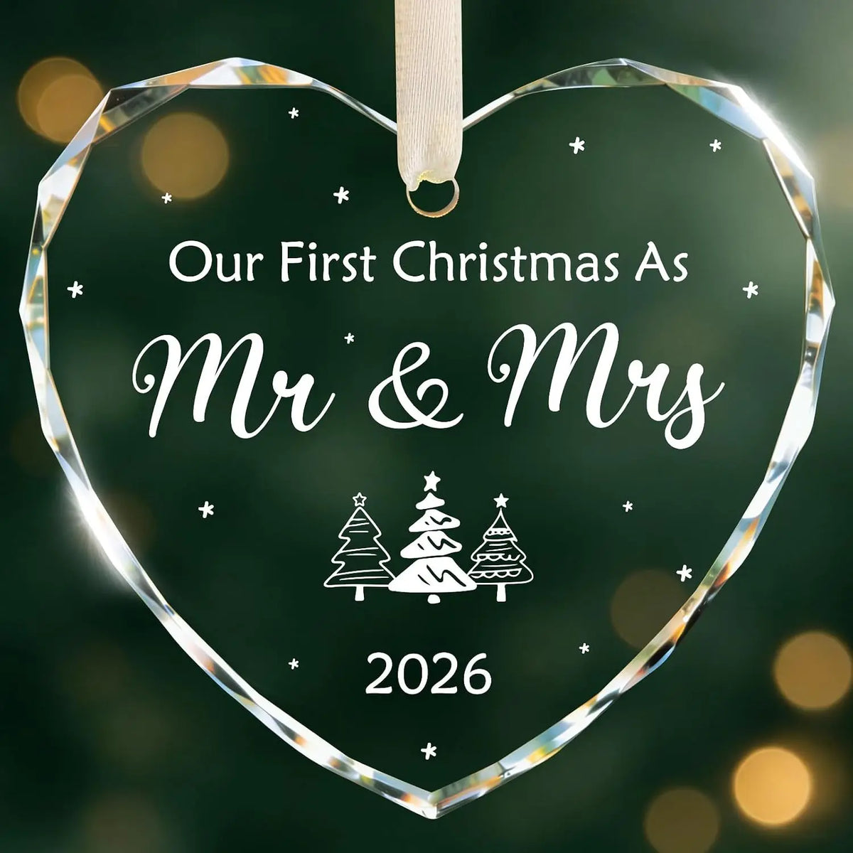 A clear heart-shaped crystal ornament with the text Our First Christmas As Mr & Mrs and the year 2026.