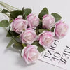 A bouquet of pink and white artificial roses on green leaves for weddings and home decor