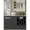 A modern bathroom interior featuring marble wall decals, a mirror, and green cabinetry.