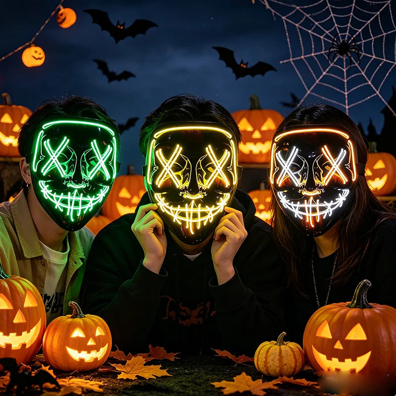 Three people wearing glow-in-the-dark LED purge masks for Halloween cosplay with carved pumpkin decorations in the background