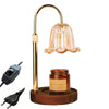 A gold-toned adjustable height aromatherapy candle warmer lamp with a glass shade and a wooden base.