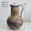 A vintage dual-sided ceramic pitcher or jug with a handle and spout, featuring mottled brown and black glaze.