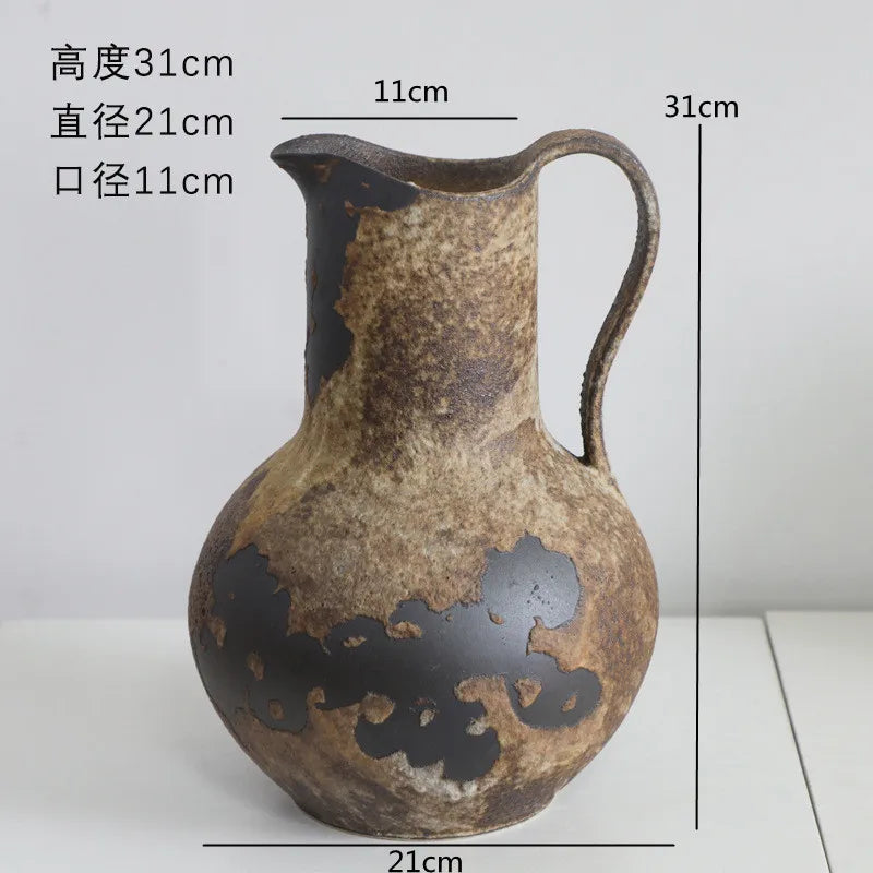 A vintage dual-sided ceramic pitcher or jug with a handle and spout, featuring mottled brown and black glaze.