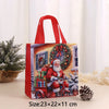 A red non-woven gift tote bag featuring a festive Christmas print of Santa and presents on a vintage bicycle.