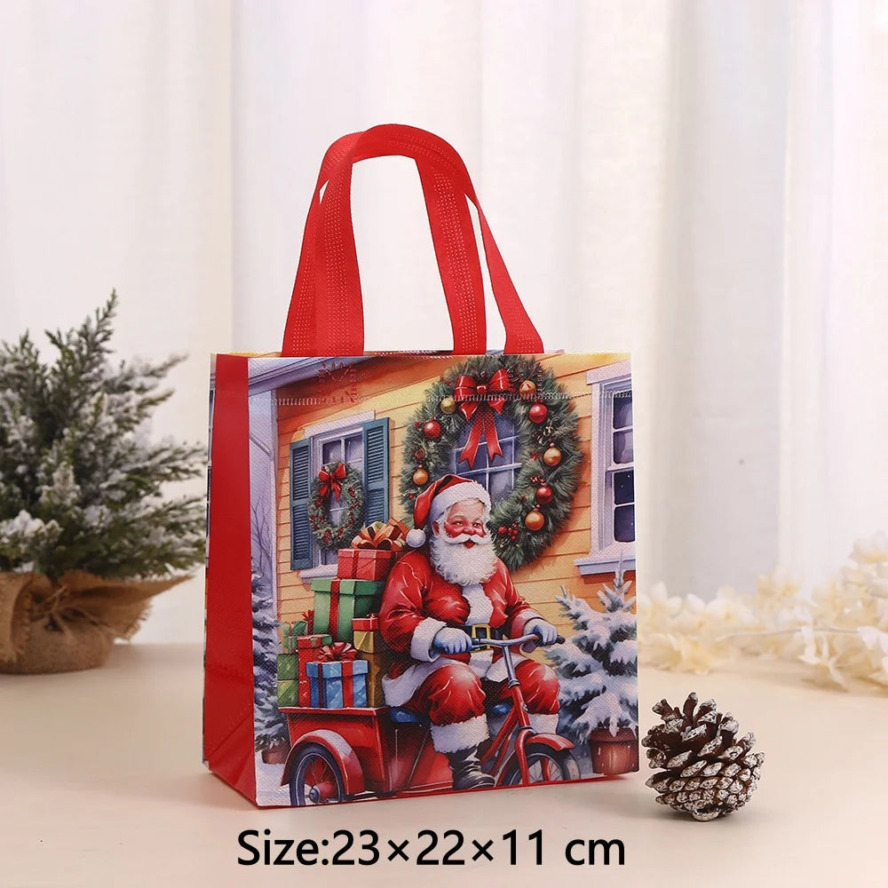 A red non-woven gift tote bag featuring a festive Christmas print of Santa and presents on a vintage bicycle.