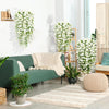 A green sofa decorated with white artificial morning glory hanging flowers and a light rug.