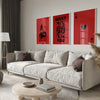A modern living room features a light sofa and wooden coffee table with a set of red framed art prints displaying the words l