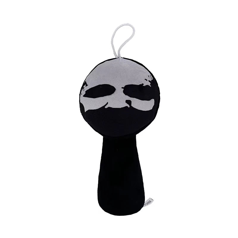 A black plush toy with a silver outline of a face and a loop for hanging.