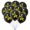 A bunch of black latex balloons featuring yellow construction tractor and excavator graphics.