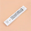 A white box containing a set of silver curved decorative candles for a birthday celebration.