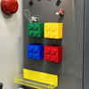 A magnetic wall-mounted kitchen storage rack featuring colorful plastic cubes and a yellow wire shelf.